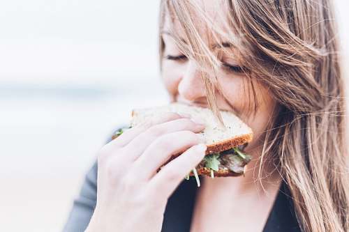 people woman eating sandwich sandwich
