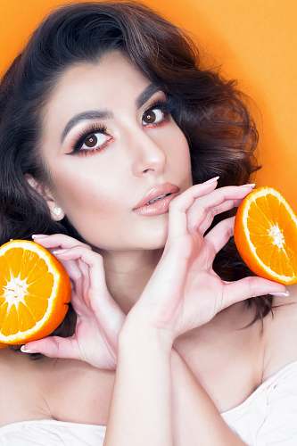 fruit woman holding two sliced lemon citrus fruit