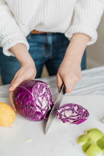 plant woman slicing purple vegetable person