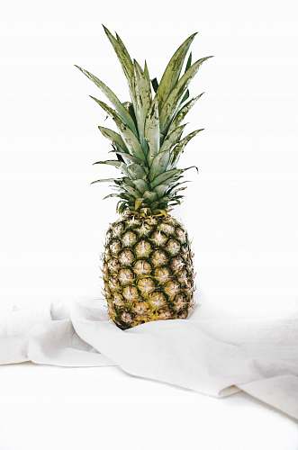fruit yellow and green pineapple fruit on white textile pineapple