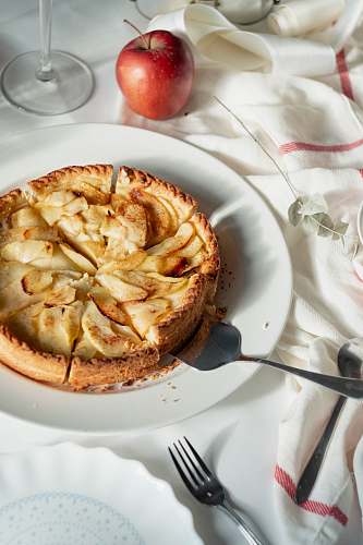 cutlery brown desert on white ceramic plate apple