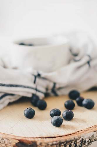 plant blueberry near white and black fabric blueberry