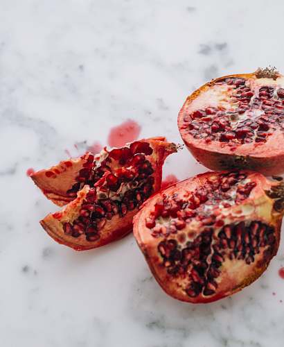 food selective focus photography of slice fruits pomegranate