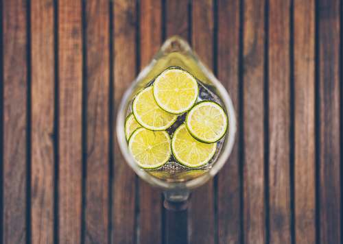plant sliced lime in clear glass pitcher citrus fruit