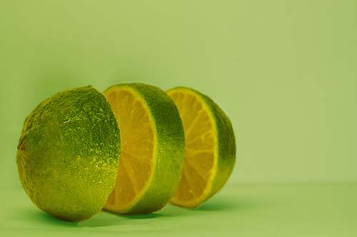 plant sliced lime on green surface citrus fruit