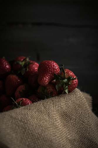food strawberries on brown textile plant