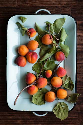 food bunch of orange fruit in pl,ate apricot
