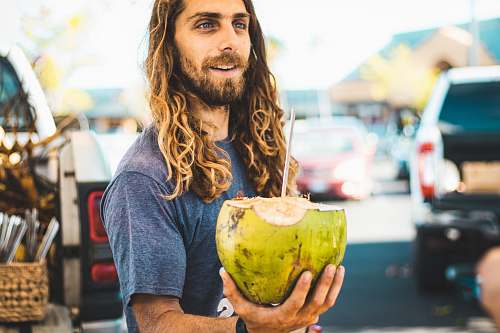 human man holding coconut fruit person