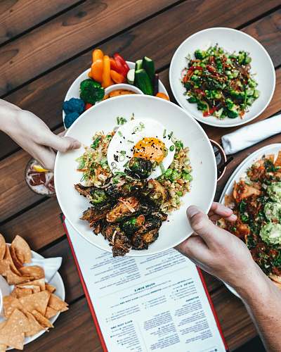 food two hands holding white plate with foods produce