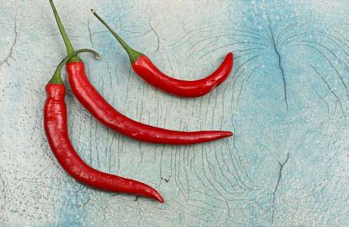 food three red chili on gray surface flora