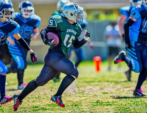  football game on grass field during daytime 