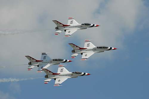  four white jet planes flying during daytime 