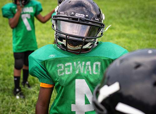 clothing boy wearing green Dawgs 4 jersey wearing black helmet helmet
