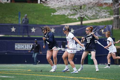 human four woman playing lacrosse sticks person