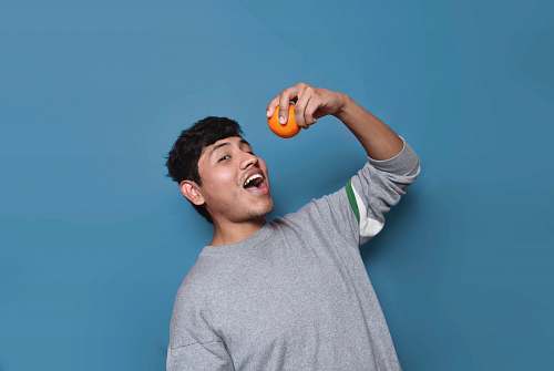 human man about to eat orange fruit person