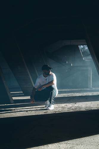 clothing man sitting on a parking lot human