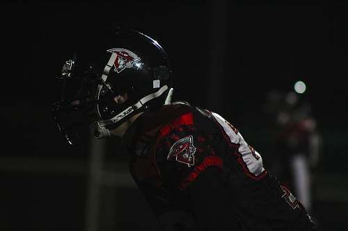 clothing man wearing red-and-black jersey shirt and black-and-white sports helmet helmet