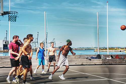 clothing men playing basketball during daytime shorts