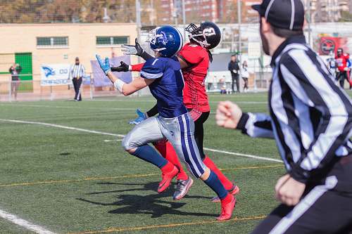 clothing men playing football at daytime helmet
