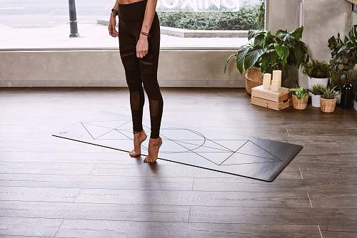 clothing person performing exercise inside room floor