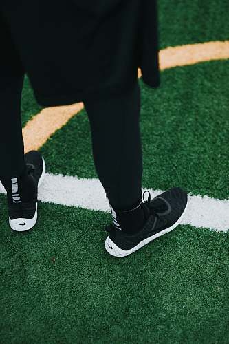 shoe person wearing black Nike shoes footwear