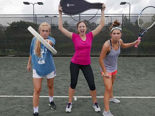 footwear three women holding tennis rackets shoe