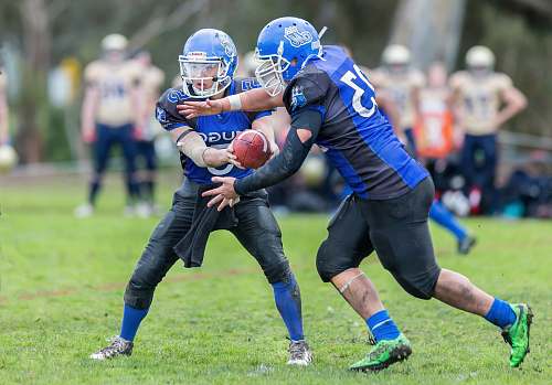 clothing time-lapse photography of men playing football in field helmet