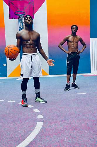 clothing two men standing near basketball hoop footwear