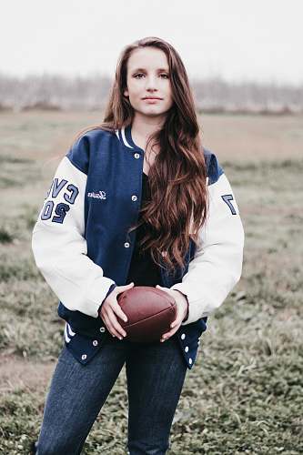 clothing woman holding football during daytime human