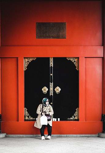 human woman sitting in front of closed door person