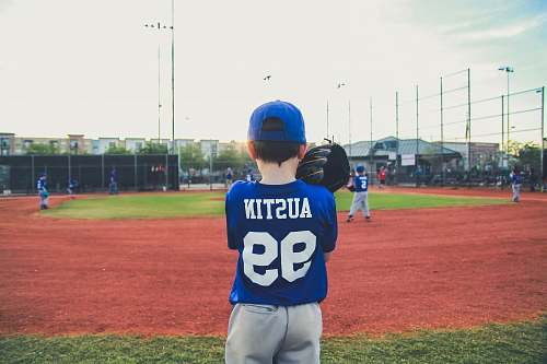 sport boy in blue and white shirt standing on green grass team sport