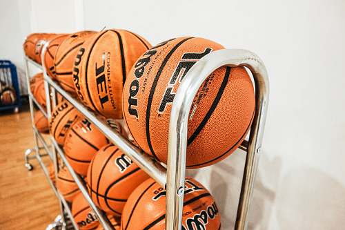 sport pile of basketballs beside wall sports