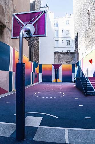 sports purple and orange basketball court during day time sport