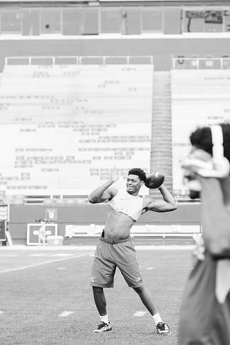 apparel grayscale photo of man playing football clothing