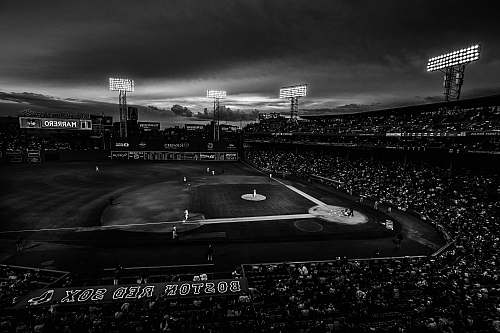 outdoors grayscale photography of baseball field with people on bleachers crowd