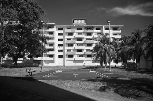 bench greyscale photography of concrete building furniture