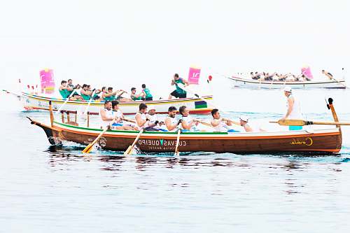 transportation group of people rowing boat vessel