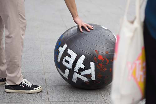 apparel man standing and touching gym ball footwear