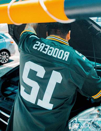 apparel man wearing green jersey shirt during daytime helmet