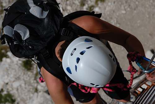 apparel person climbing on gray stainless steel ladder helmet