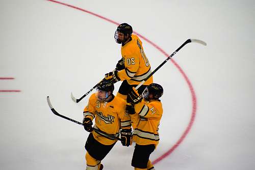 apparel three hockey players on focus photography helmet