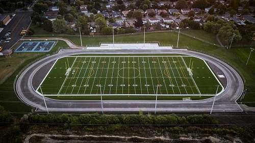 people aerial photo of field building