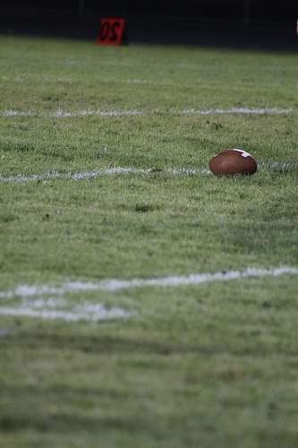 building brown football on field grey