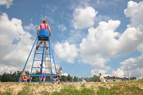 summer group of teens playing volleyball girl sitting on umpire's chair playing
