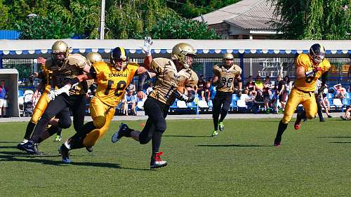 apparel men playing football at stadium clothing