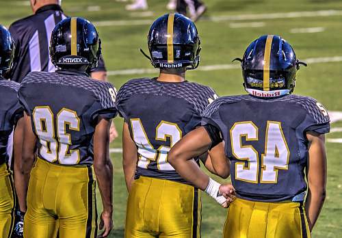 football three football players standing on football field sports