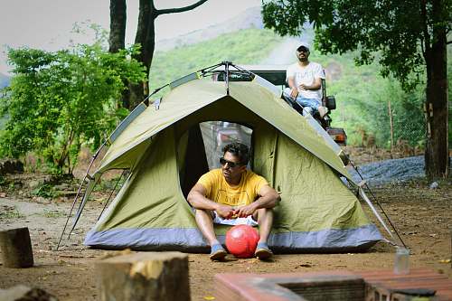 person 2 men camping tent