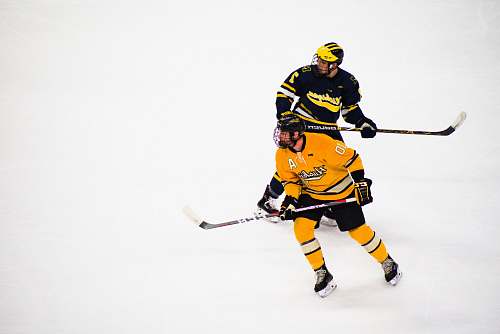 person 2 men playing hockey hockey