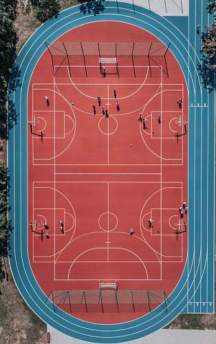 person aerial photo of basketball court red