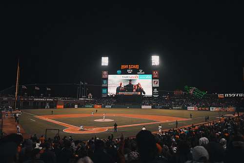 person baseball field at daytime building